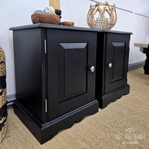 Side view of a pair of Coal Black painted pine cupboards with silver knobs and hinges