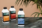 Load image into Gallery viewer, Three bottles of Polyvine decorative effects scumble on a faux painted marble surface with a plant in the background.
