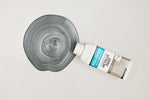 Load image into Gallery viewer, Bottle of Pewter Polyvine Metallic Paint being poured onto a pale grey surface
