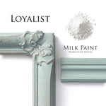 Load image into Gallery viewer, Homestead House Milk Paint Loyalist Flat Lay with powder, painted trim and distressed photo frame
