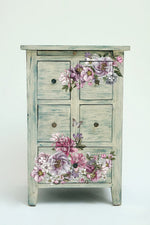 Load image into Gallery viewer, Dreamy Florals Redesign with Prima Small Transfer - mauve, burgundy and purple florals on the front of a weathered green distressed cabinet
