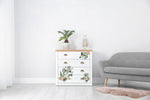 Load image into Gallery viewer, Greenery House Redesign with Prima Small Transfer - modern flat tropical leaves in shades of green and terracotta decorating the front of a plain white chest of drawers
