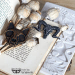 Load image into Gallery viewer, Amun and Bast Redesign with Prima Mould - animal skulls, wings, rivets and bolts in a steampunk gothic style psinted in copper and steel with seed pods on a vintage book
