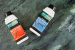 Load image into Gallery viewer, Two bottles of Polyvine Scumble paint on a faux marble painted green surface
