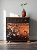 Load image into Gallery viewer, Feathers In The Glow Redesign with Prima Decoupage Fibre Paper with swallows and white flowers on a copper ground on the front of a dark charcoal grey chest of drawers
