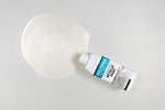 Load image into Gallery viewer, Bottle of Pearl Polyvine Metallic Paint being poured onto a pale grey surface

