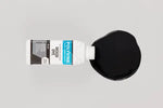 Load image into Gallery viewer, Black Polyvine interior and exterior wood dye being poured onto a surface
