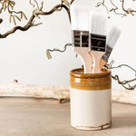 Load image into Gallery viewer, 3 Polyvine varnish brushes in a ceramic vase in a rustic setting with a twiggy branch
