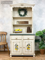 Load image into Gallery viewer, Lemon Tree Redesign with Prima Small Transfer - realistic watercolour lemons hanging on branches, plus a blue geometric tile design on the front of an aged white painted country dresser
