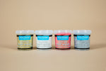 Load image into Gallery viewer, Range of four containers of Polyvine Glitter Paint Maker on a beige background
