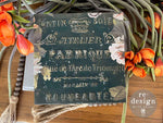 Load image into Gallery viewer, Satin Soie Redesign with Prima Stencil from the Kacha Collection featuring vintage french typography embossed on top of a little green table with florals
