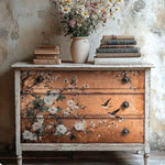Load image into Gallery viewer, Distressed white chest of drawers featuring Feathers In The Glow Redesign with Prima Decoupage Fibre Paper with swallows and white flowers on a copper ground
