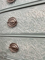 Load image into Gallery viewer, Elegant Lace Redesign with Prima Border Stencil to create a raised stencil, grey chest of drawers with distessed white liming wax limed effect
