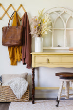 Load image into Gallery viewer, Homestead House Milk Paint Swedish Yellow painted console table with dark wood legs close up
