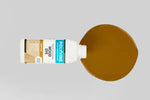 Load image into Gallery viewer, Light Oak Polyvine interior and exterior wood dye being poured onto a surface
