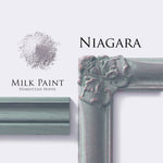 Load image into Gallery viewer, Homestead House Milk Paint Niagra Flat Lay with powder, painted trim and aged photo frame

