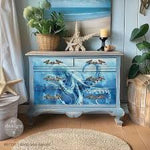 Load image into Gallery viewer, Chest of drawers featuring the Deep Sea Dancer Redesign with Prima Decoupage Fibre Paper featuring a large octopus in monotone shades of watery blue in a beach themed room
