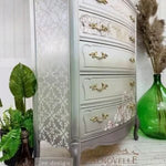 Load image into Gallery viewer, Gothic Trellis Redesign with Prima Stencil on the side of a silver grey chest of drawers
